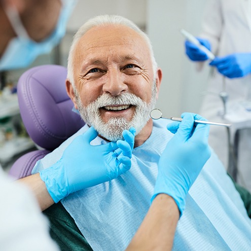 A man smiling at the dentist