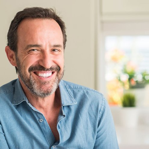 Reno patient smiling confidently with new dentures