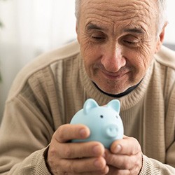 Man holding a blue piggy bank