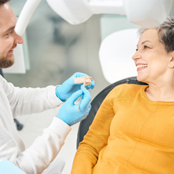 Dentist discussing how a smile makeover works with patient 