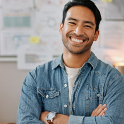 Young man smiling happily after a smile makeover 