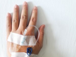 Close-up of person's hand with IV in it