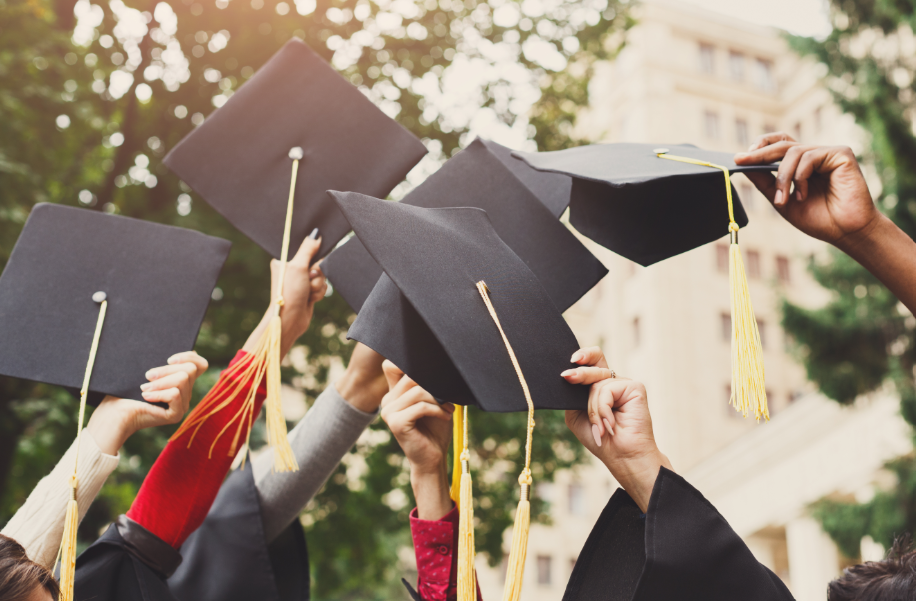 Grads holding caps in the air