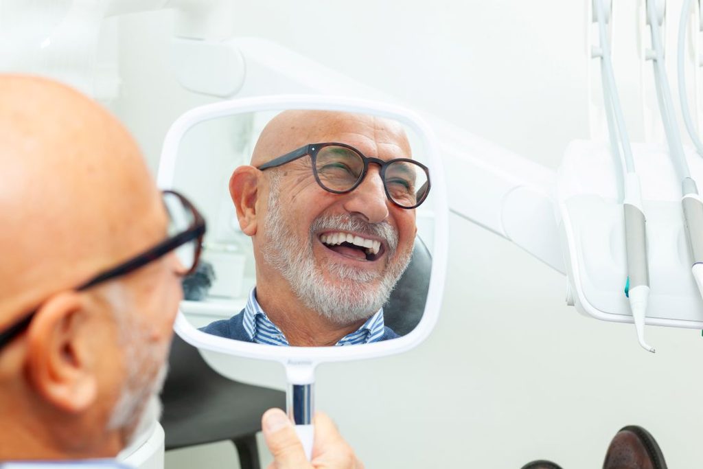 A man smiling in the mirror